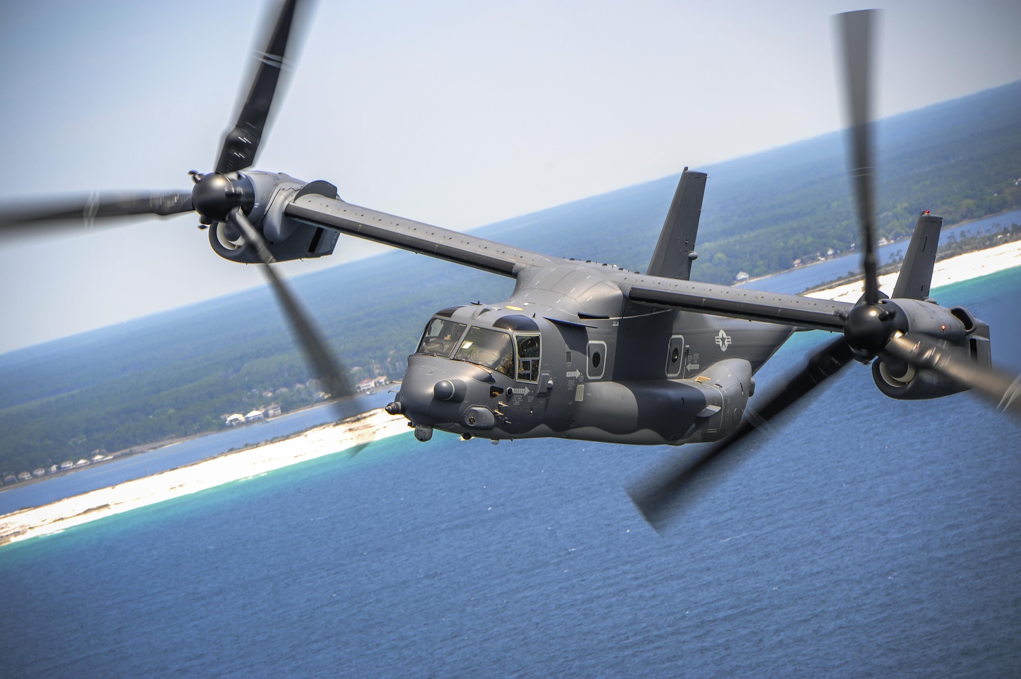 A CV-22 Osprey flies in formation with a MC-130H Combat Talon II over Fort Walton Beach, Fla., April 24, 2015. Two Ospreys trailed a MC-130 Combat Talon II during a flyover of the Hurlburt Field, Fla., Airpark during an annual Operation Eagle Claw ceremony.  (U.S. Air Force photo/Senior Airman Christopher Callaway)