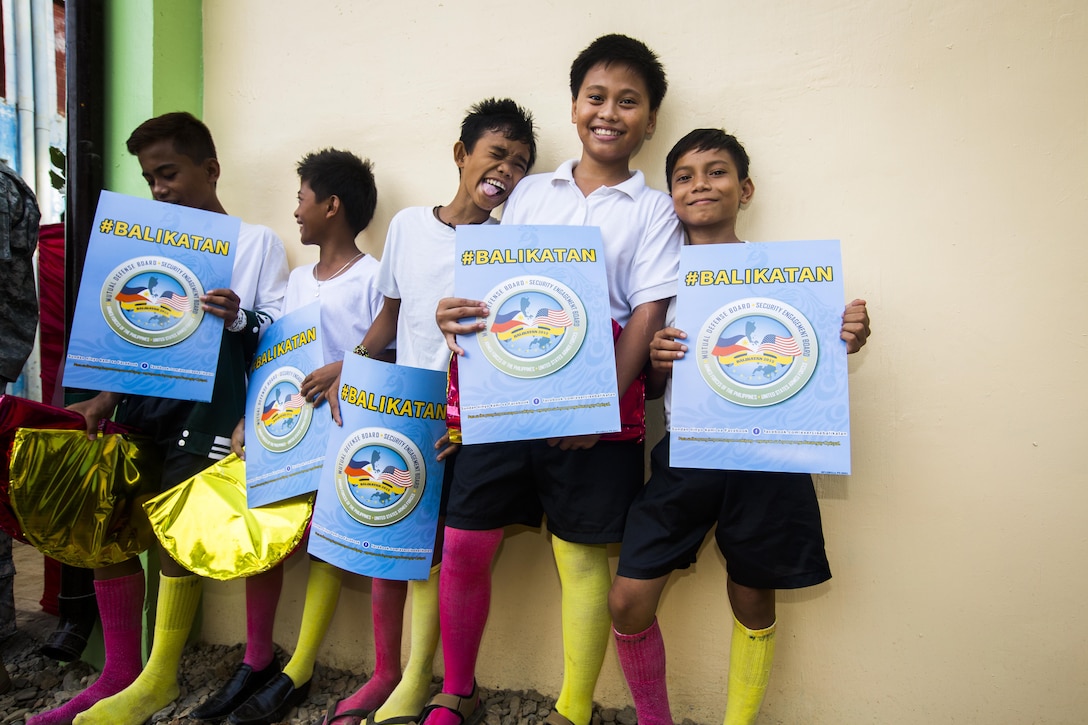 Students of the Sabang Elementary School hold posters for Balikatan 2015 before the ribbon cutting ceremony for the school's new classrooms in Puerto Princesa, on the island of Palawan, Philippines, during the exercise, April 28. The ribbon cutting ceremony was chance for members of the community and military come together and celebrate the recently finished classroom. The exercise provides an opportunity for Philippine and U.S. forces to continue strengthening relationships and work together.