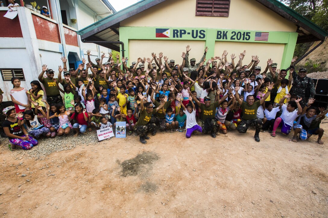 Armed Forces of the Philippines, U.S. forces, and civilians come together for the ribbon cutting ceremony at Sabang Elementary School for new classrooms built in Puerto Princesa, Philippines, during exercise Balikatan 2015, April 28. The ribbon cutting ceremony was chance for members of the community and military come together and celebrate the recently finished classroom. Balikatan provides an opportunity for Philippine and U.S. forces to continue strengthening relationships and work together.