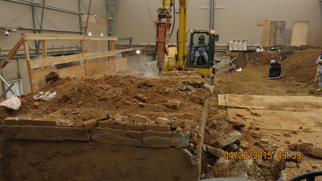 Crews are scrapping and digging the soils and concrete in the former back porch area, as they progress down to grade