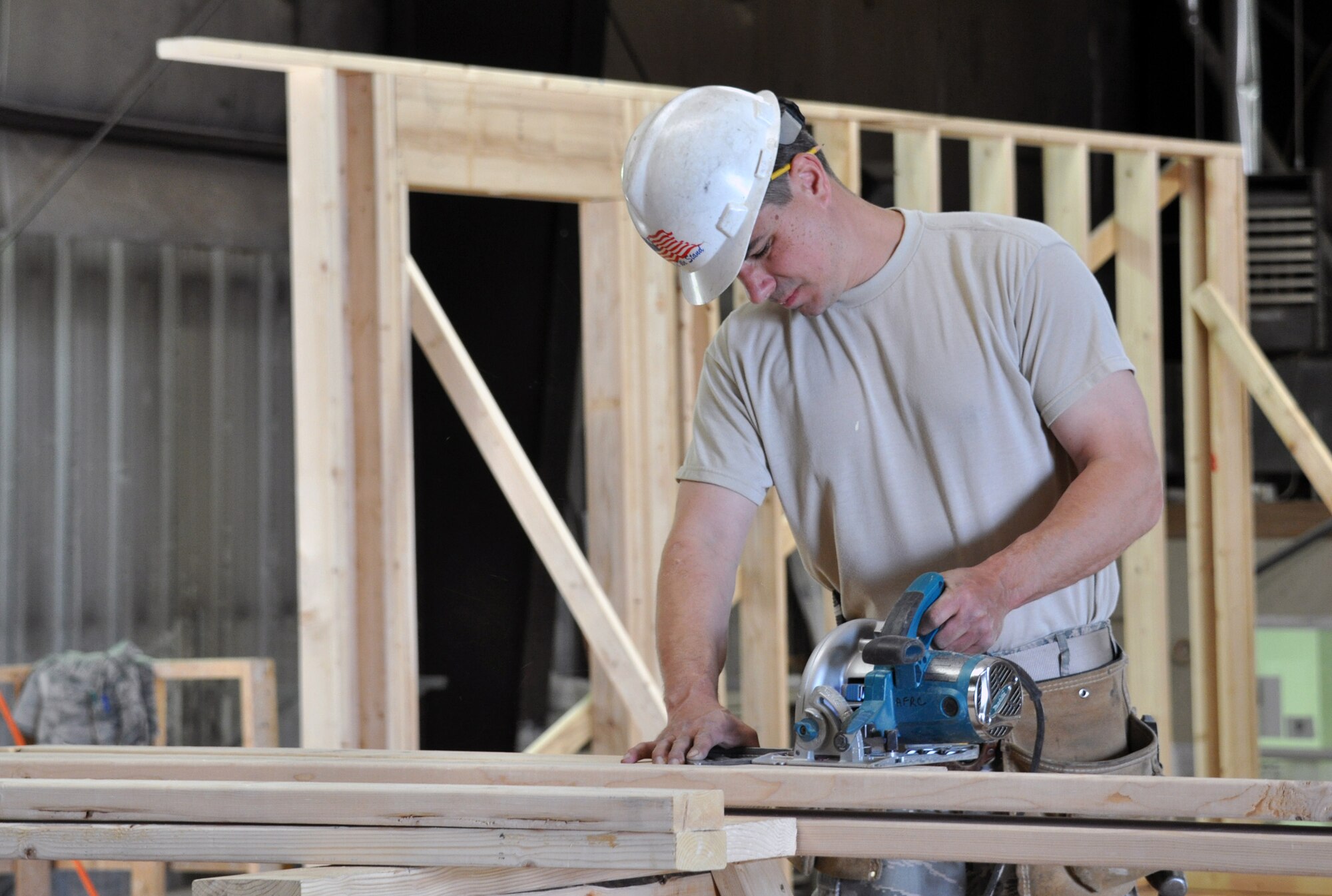 Master Sgt. Frank Monacelli, a structures specialist with the 911th Airlift Wings’ Civil Engineer Squadron, cuts two-by-fours for the walls of a home being built for members of the local Navajo Nation around the town of Gallup, N.M., April 23. (U.S. Air Force Photo by Senior Airman Joseph E. Bridge)