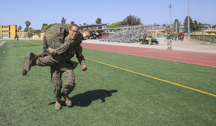 Private First Class Mark-Louie H. Taocta, Platoon 1007, Alpha Company, 1st Recruit Training Battalion, fireman carries his partner during the Combat Fitness Test at Marine Corps Recruit Depot San Diego, April 9.  Taocta moved to the United States at the age of 15 not knowing any English or having an understanding of the American culture.  He quickly overcame this challenge and decided to join the Marine Corps after being inspired by his father who served in the Philippine Marine Corps.