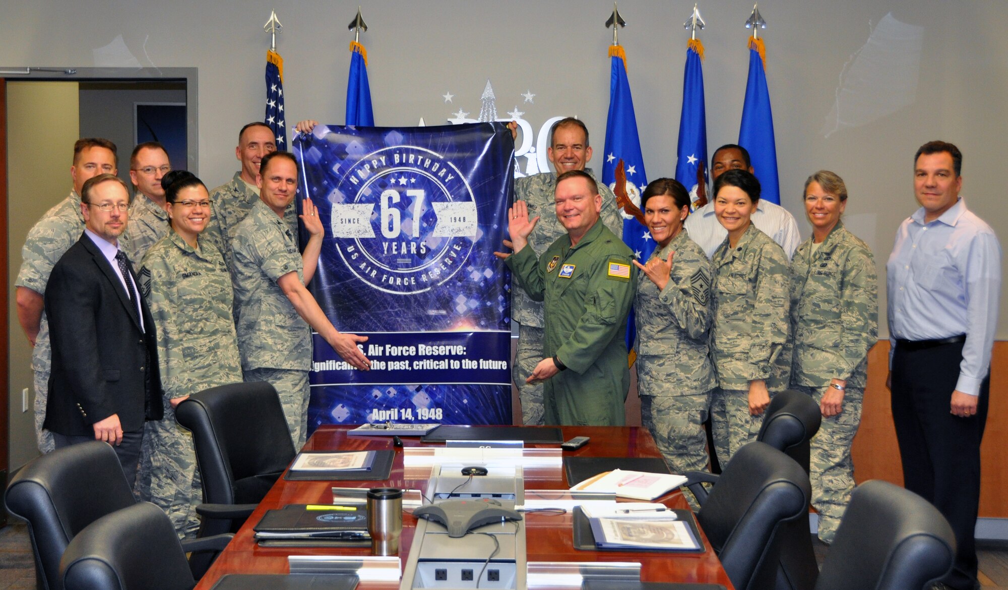 In honor of the Air Force Reserve's 67th anniversary, Air Reserve Personnel Center took photos with a commemorative banner at various events. Here, leaders from ARPC pose for a shot during their staff meeting April 13, 2015, on Buckley Air Force Base, Colo. (U.S. Air Force photo/Tech. Sgt. Robert Hazelett)