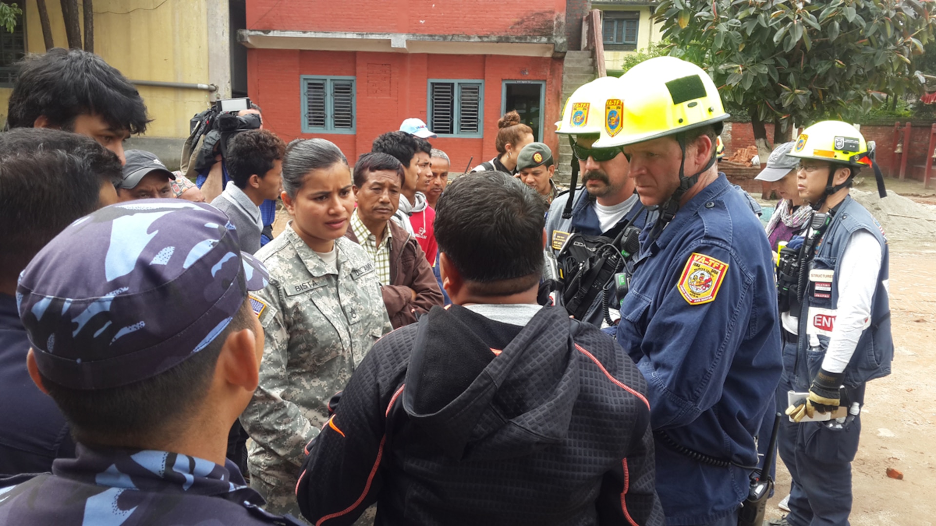 Nepal (Apr. 29, 2015) - A member of the U.S. Civil Military Support Element (CMSE) Nepal talks with USAID Disaster Assistance Response Team (DART) Search and Rescue team from Fairfax County, VA. The CMSE arranged for the SAR team to meet with the Deputy Superintendent Police for Bhaktapur to better synchronize search and rescue efforts. 