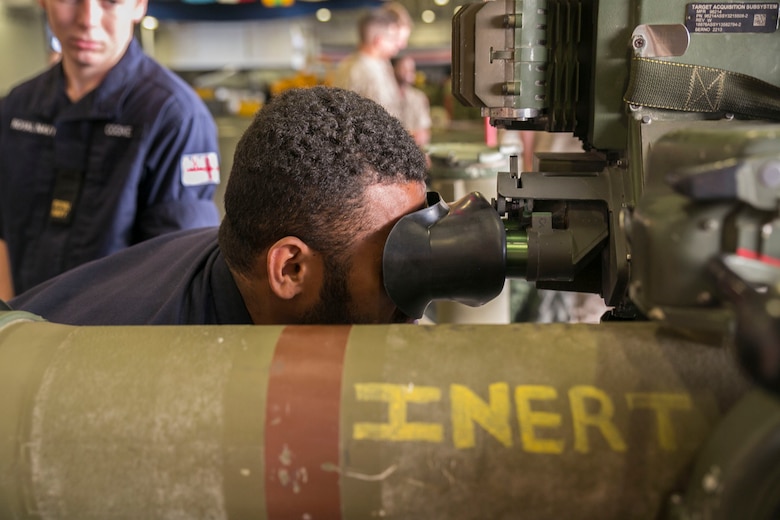 British Royal Navy Able Seaman Ratu Rodelana, logistics steward with the HMS Lancaster, looks through the scope of an M40A5 sniper rifle during a tour aboard the amphibious assault ship USS Wasp (LHD 1) while out at sea April 30, 2015. U.S. Marines and U.S. Navy Sailors with the 22nd Marine Expeditionary Unit from Marine Corps Base Camp Lejeune, N.C., participated in Navy Week 2015 in New Orleans April 23-29 and Fleet Week Port Everglades, Fla., May 4-10. The purpose of Navy Week was to showcase the strength and capabilities of the Navy-Marine Corps team through tours, static displays and community relations events, providing the public the opportunity to meet and interact with Marines and Sailors. (U.S. Marine Corps photo by Sgt. James R. Smith/Released)
