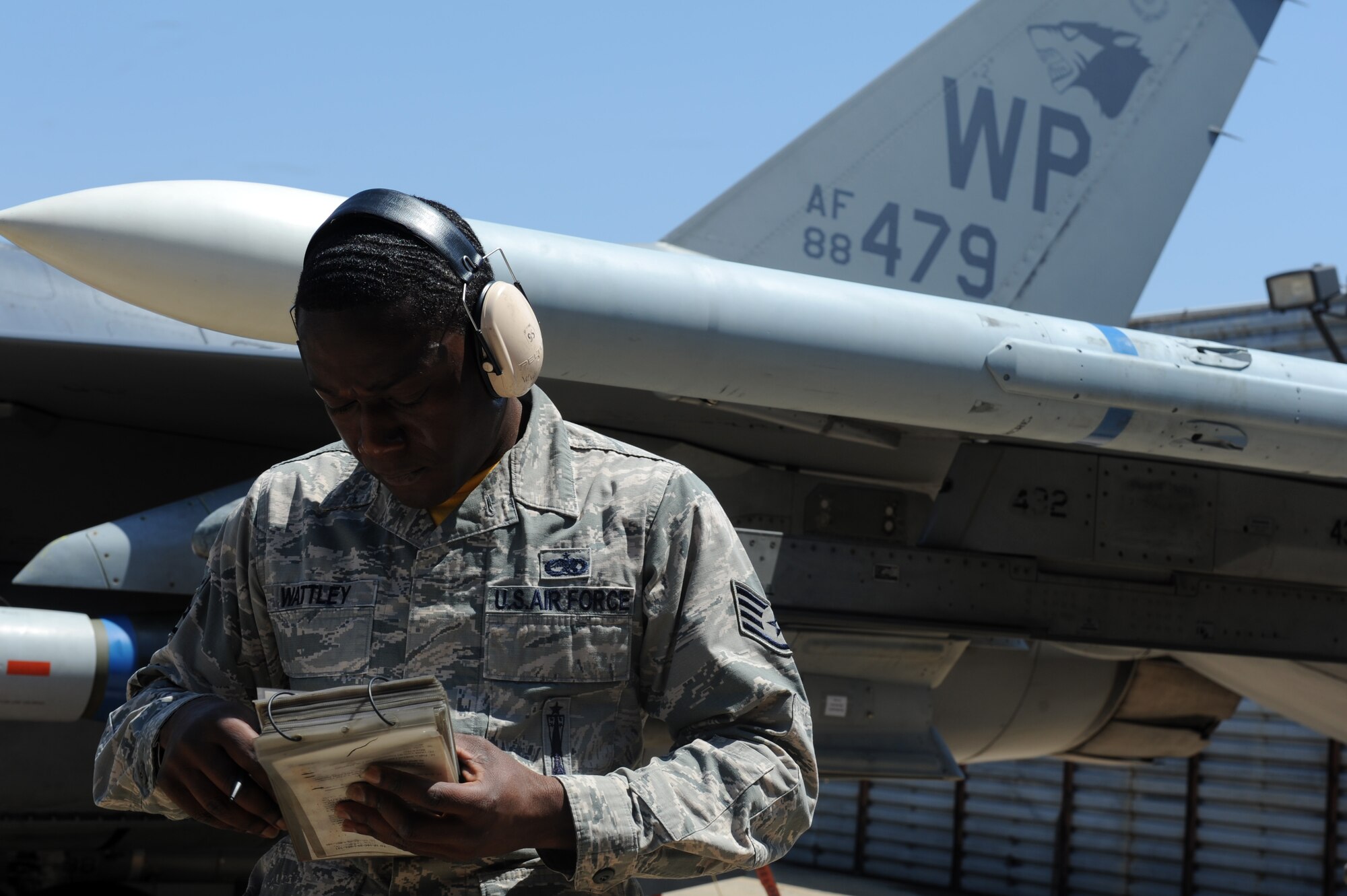 Staff Sgt. William Wattley, 80th Aircraft Maintenance Unit team chief, reviews a munitions loading checklist during the 2015 peninsula-wide load competition at Kunsan Air Base, Republic of Korea, April 25, 2015. The competition  had six teams representing the 35th and 80th Aircraft Maintenance Units, the 120th Expeditionary AMU, ROKAF’s 38 Maintenance Squadron, and the 36th and 25th AMUs from Osan AB. (U.S. Air Force photo by Senior Airman Divine Cox/Released)