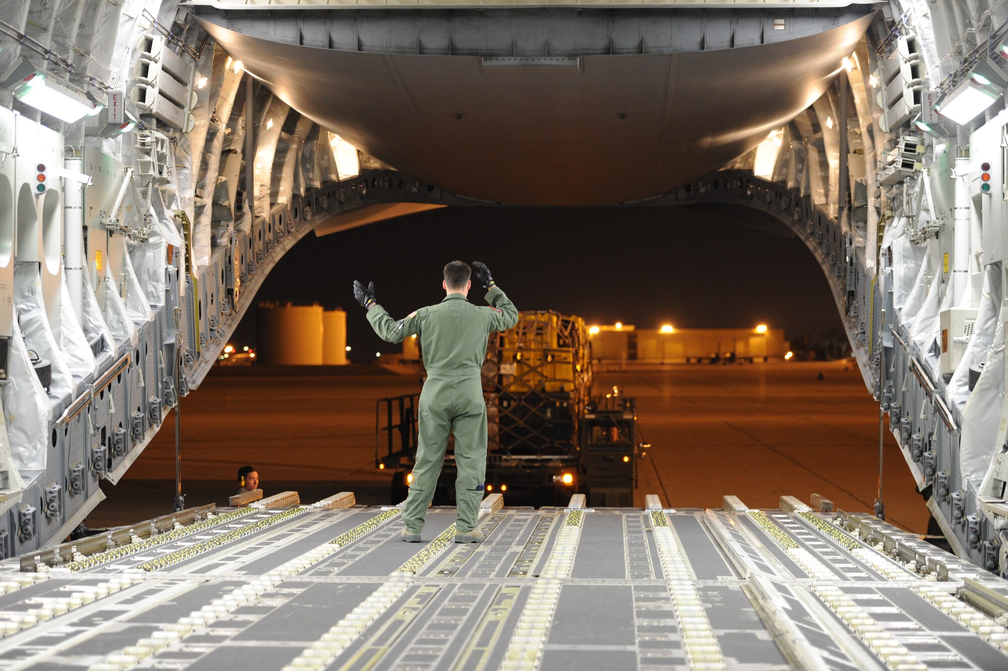 Senior Airman Evan Austin, 15th Airlift Squadron, loadmaster, Joint Base Charleston, S.C., directs a 60-K Loader carrying emergency search and rescue equipment on the flight line at March Air Reserve Base, Calif., April 26, 2015. The cargo includes sonar detection devices, heavy concrete cutting equipment, generators and more that will be used by an elite 57-person team, known as the Urban Search and Rescue Task Force 2 (CA-TF2), in support of earthquake emergency rescue operations in Nepal. (U.S. Air Force photo/Senior Airman Russell S. McMillan)