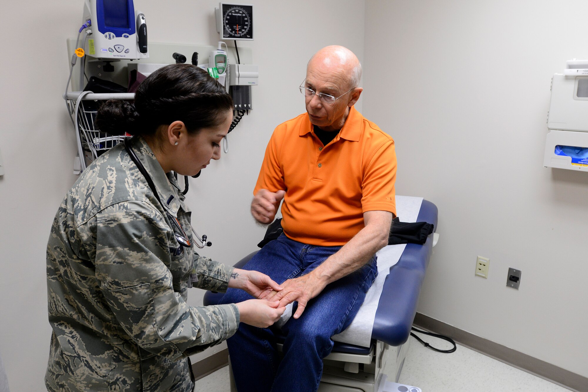 1st Lt. Marina Puentes 22nd Medical Operations Squadron Physician Assistant, checks a patient’s hand, April 22, 2015, at McConnell Air Force Base, Kan. Puentes is one of three PAs at Team McConnell and is part of a team who serves more than 11,000 beneficiaries across Team McConnell. (U.S. Air Force photo by Senior Airman Trevor Rhynes)