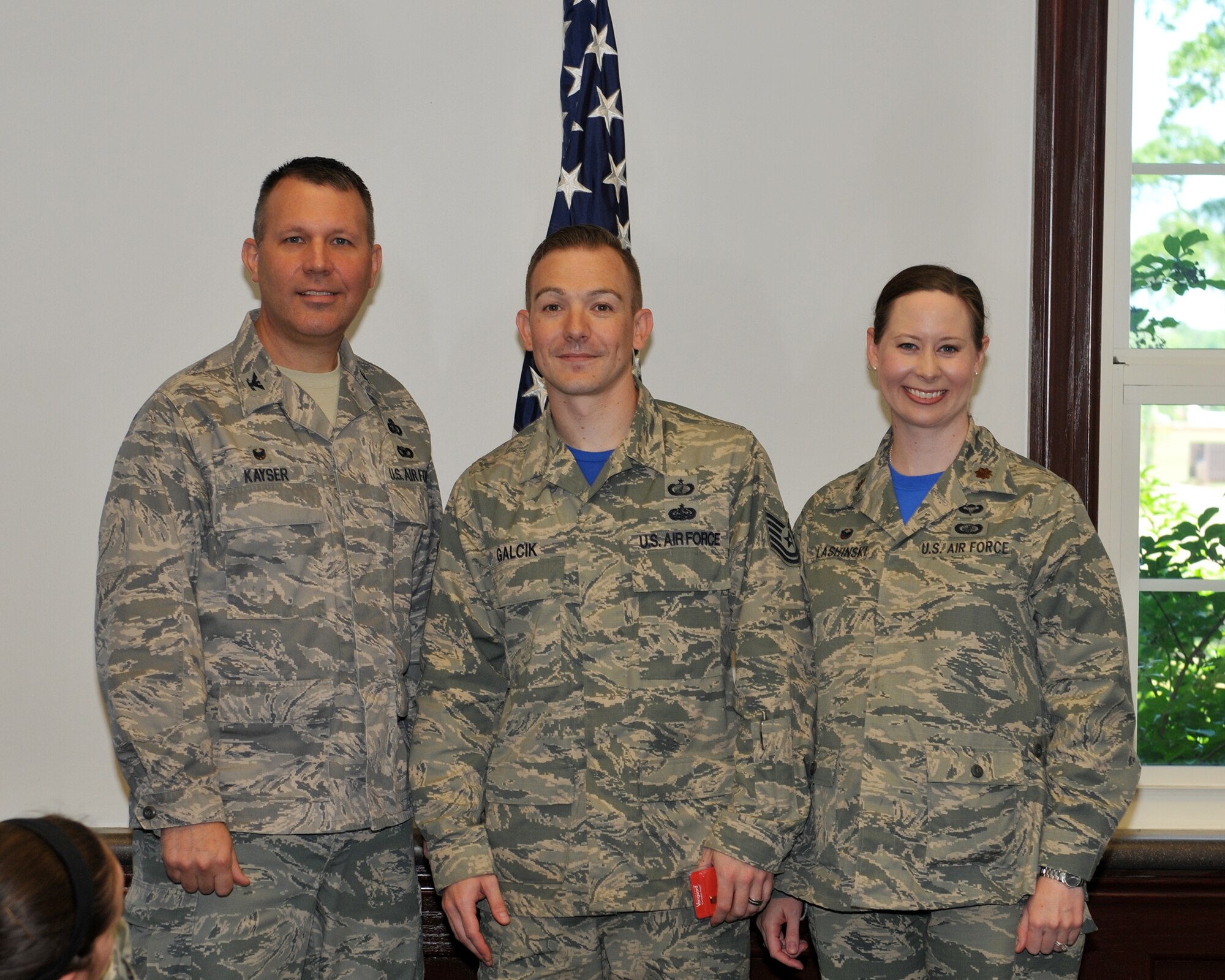 Col. Kurt Kayser, 14th Mission Support Group Commander, and Maj. Miranda Lashinski, 14th Contracting Squadron Commander, congratulate Tech. Sgt. Bryan Galcik, 14th CONS, May 1 in the Contracting office on Columbus Air Force Base, Mississippi. Galcik was accepted into Officer Training School, a nine-week U.S. Air Force commissioning program located at Maxwell Air Force Base, Alabama .  When deciding who should attend OTS, the selection board reviews numerous factors such as an grade point average and Air Force Officer Qualifying Test scores, as well as work experience, accomplishments, adaptability, character, leadership ability and potential for future growth. 