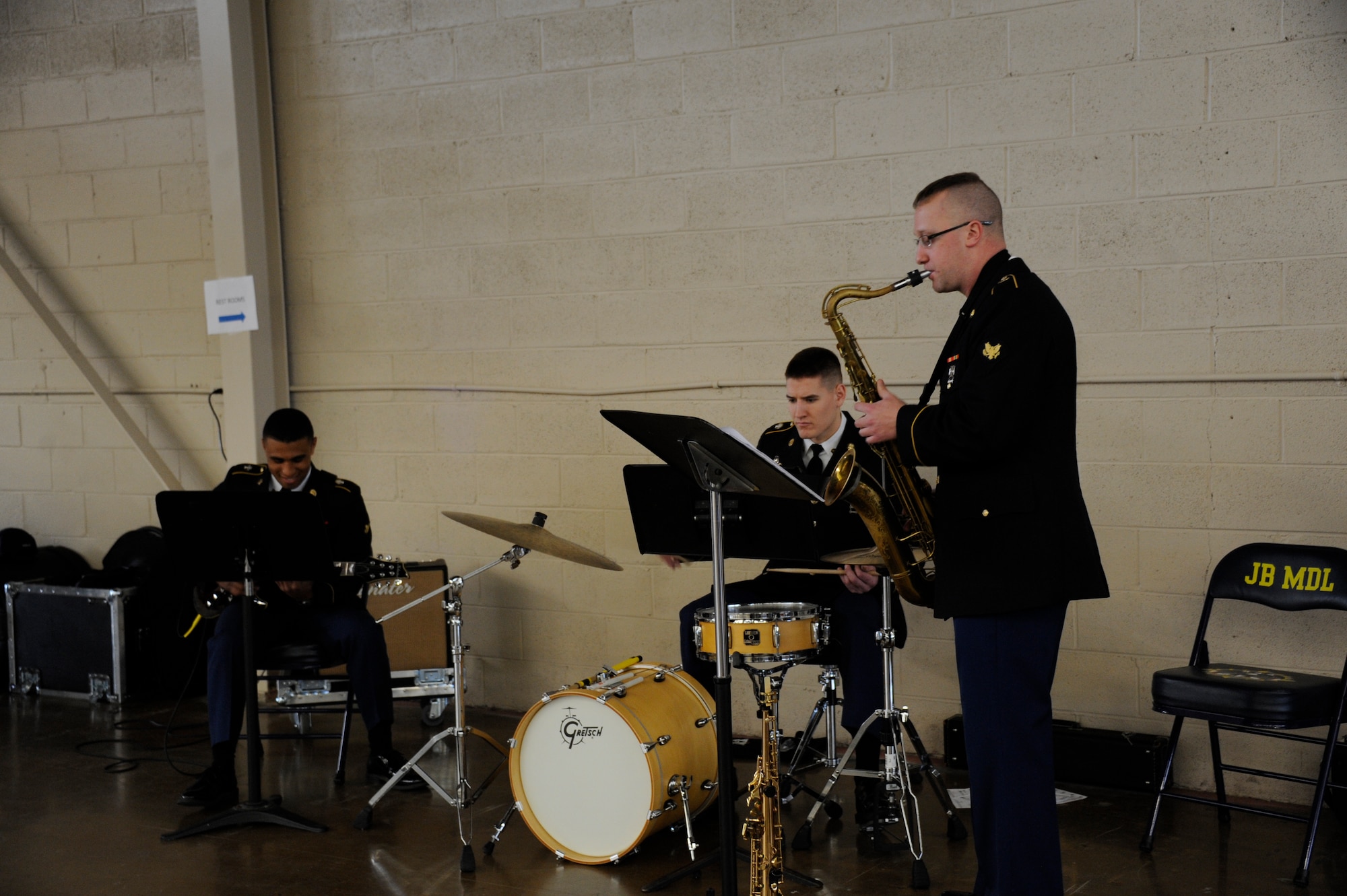 Soldiers from the Jazz Trio, 198th Army Reserve Band, from Rochester, N.Y., provide entertainment during the first Joint Retiree Appreciation Day held at Joint Base McGuire-Dix-Lakehurst for veterans from all military branches March 25, 2015. (U.S. Air Force photo by Pascual Flores/Released)