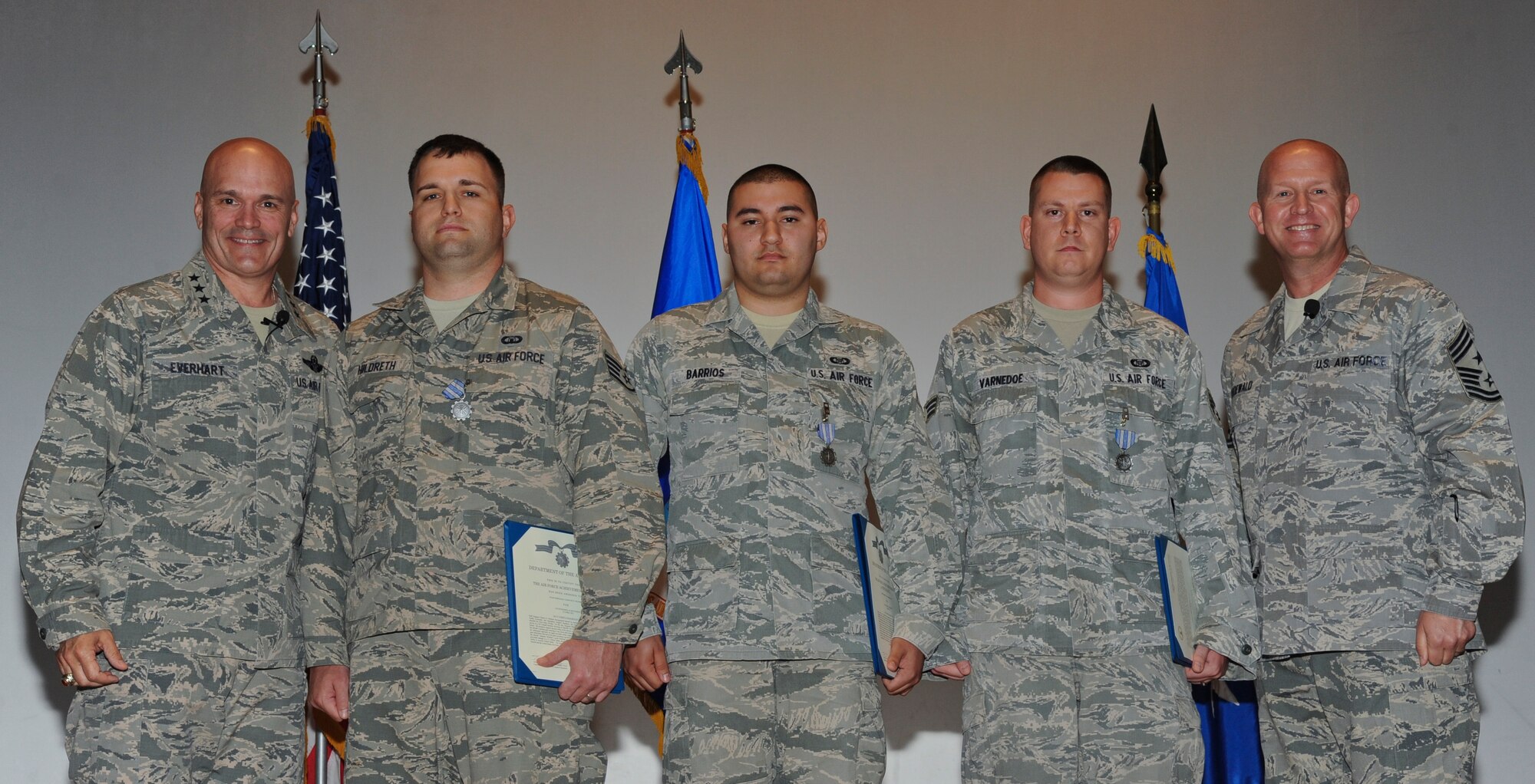 Lt. Gen. Carlton D. Everhart II, 18th Air Force commander, and Chief Master Sgt. Robert Rodewald, 18th Air Force Command Chief, pose for a group photo after an awards presentation at MacDill Air Force Base, Fla., April 29, 2015. During his visit Everhart awarded three Airmen with the Air Force Achievement Medal for outstanding achievement and meritorious service. (U.S. Air Force photo by Airman 1st Class Danielle Conde/Released)