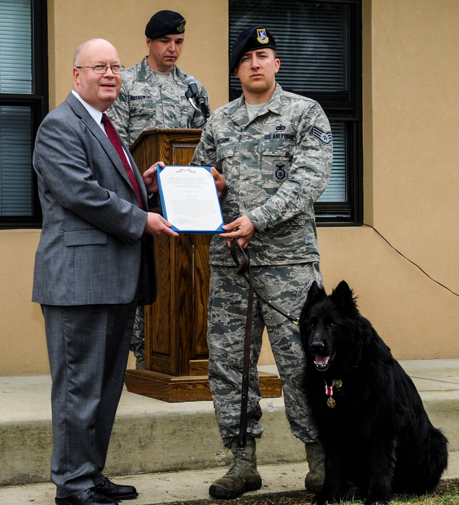 Sam, military working dog, is awarded the Meritorious Service Medal during a retirement ceremony on Joint Base Andrews, Md., May 1, 2015. After the ceremony, Sam was collected by one of his previous handlers, who traveled from Germany to retrieve him. (U.S. Air Force photo/ Senior Airman Mariah Haddenham)