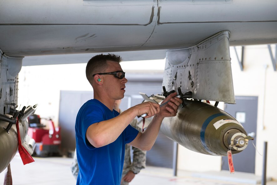 U.S. Air Force Staff Sgt. Scotty Loga, 74th Aircraft Maintenance Unit weapons load crew member, tightens a sway-brace on a bomb rack during the load crew of the quarter competition April 24, 2015, at Moody Air Force Base, Ga. Each weapons load crew had to load an AIM-9 missile, one MK-82 AIR bomb and one GBU-12 bomb during the competition. (U.S. Air Force photo by Airman Greg Nash/Released)
