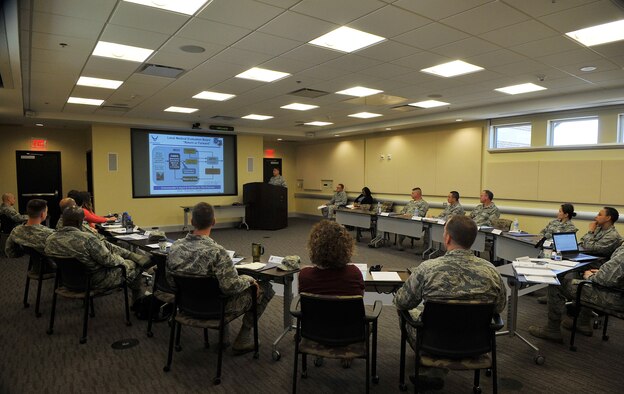 A group of incoming commanders listen to a medical readiness briefing at the Smart Conference Center at Joint Base Andrews, Md., April 29, 2015. This briefing is one of the many these officers and their spouses will attend during a three-day course designed to equip them for the unique issues of commanding an organization in the National Capital Region. (U.S. Air Force photo/James Lotz)