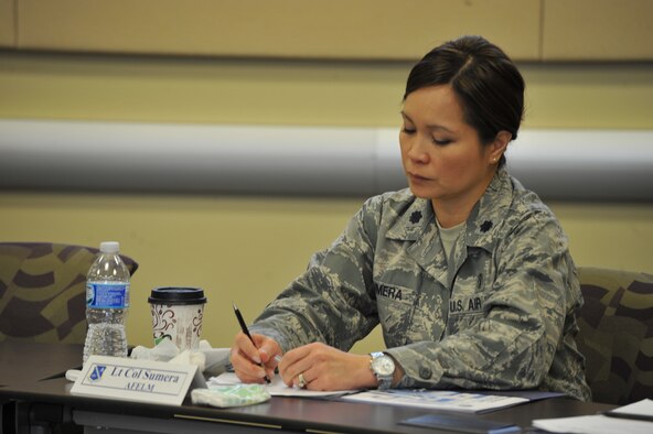 Lt. Col. Madelaine Sumera takes notes from the Commanders’ Panel at the Smart Conference Center at Joint Base Andrews, Md., May 1, 2015. This briefing is one of the many these officers and their spouses will attend during a three-day course designed to equip them for the unique issues of commanding an organization in the National Capital Region. (U.S. Air Force photo/2nd Lt. Esther Willett)