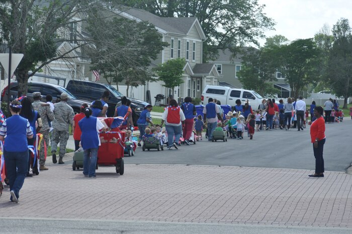Children from the General Thomas R. Mikolajcik Child Development Center at Joint Base Charleston, S.C., walk in a parade April 30, 2015 in recognition of National Child Abuse Prevention Month. The parade began at the front of the CDC and continued down Miller Avenue into base housing and back. National Child Abuse Prevention Month occurs every year during the month of April and is a time to acknowledge the importance of families and communities working together to prevent child abuse and neglect, and to promote the social and emotional well-being of children and families. (U.S. Air Force photo / Trisha Gallaway) 