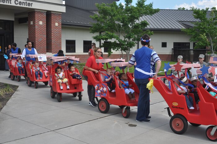 Children from the infant room at the General Thomas R. Mikolajcik Child Development Center at Joint Base Charleston, S.C., stroll along in a parade April 30, 2015 in recognition of National Child Abuse Prevention Month. The parade began at the front of the CDC and continued down Miller Avenue into base housing and back. National Child Abuse Prevention Month occurs every year during the month of April and is a time to acknowledge the importance of families and communities working together to prevent child abuse and neglect, and to promote the social and emotional well-being of children and families. (U.S. Air Force photo / Trisha Gallaway) 