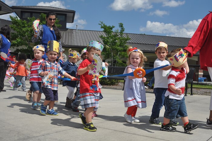 Children from the General Thomas R. Mikolajcik Child Development Center at Joint Base Charleston, S.C., walk in a parade April 30, 2015 in recognition of National Child Abuse Prevention Month. The parade began at the front of the CDC and continued down Miller Avenue into base housing and back. National Child Abuse Prevention Month occurs every year during the month of April and is a time to acknowledge the importance of families and communities working together to prevent child abuse and neglect, and to promote the social and emotional well-being of children and families. (U.S. Air Force photo / Trisha Gallaway) 