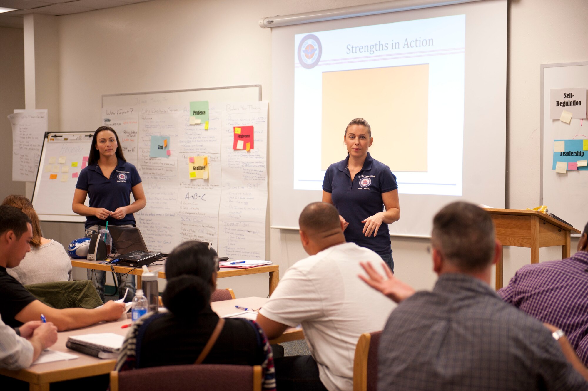Jenna Lightfoot, (right) 99th Force Support Squadron Airman and Family Readiness Center lead master resiliency instructor, and Master Sgt. Marcy Holland, 99th FSS career assistance advisor, talk with a resiliency class on Nellis Air Force Base, Nev., April 23, 2015. The class identified character strengths and weaknesses and helps them take away a set of skills that will make them stronger, more productive and effective. (U.S. Air Force photo by Airman First Class Rachel Loftis)
 
