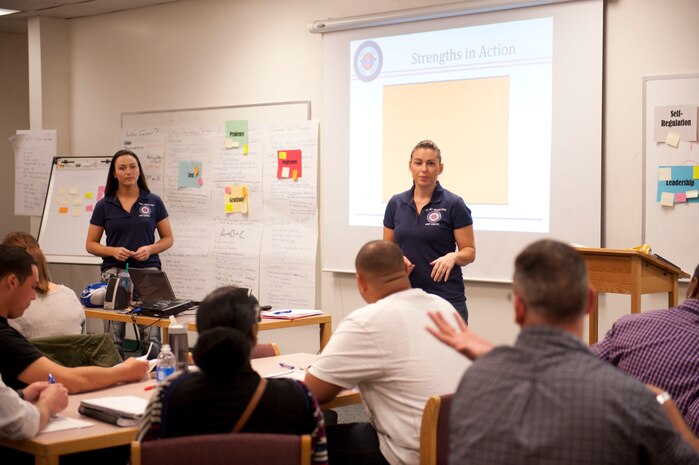 Jenna Lightfoot, (right) 99th Force Support Squadron Airman and Family Readiness Center lead master resiliency instructor, and Master Sgt. Marcy Holland, 99th FSS career assistance advisor, talk with a resiliency class on Nellis Air Force Base, Nev., April 23, 2015. The class identified character strengths and weaknesses and helps them take away a set of skills that will make them stronger, more productive and effective. (U.S. Air Force photo by Airman First Class Rachel Loftis)
 
