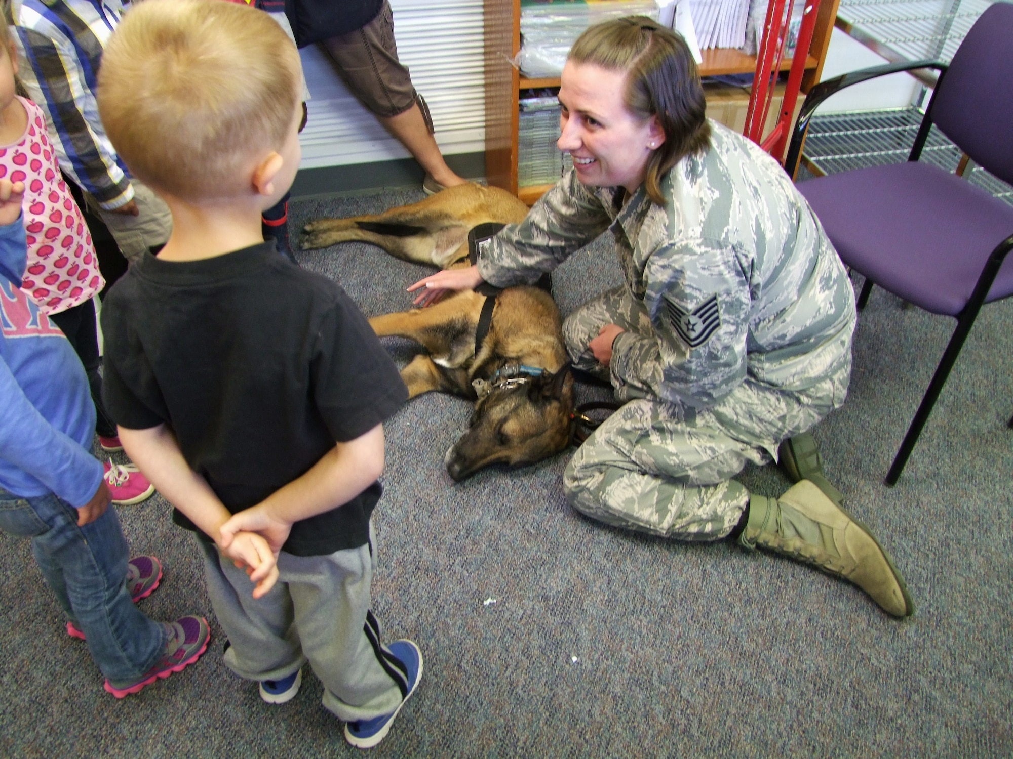 Tech. Sgt. Ashley-Marie Umstead, a 10th Security Forces Squadron flight chief, introduces Sato to preschoolers at the Child Development Center Annex April 29. 