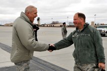 Col. Paul Bauman, 319th Air Base Wing commander, greets Col. Kevin Culp, Air Mobility Command Inspector General capstone team member, on the flightline on Grand Forks Air Force Base, N.D., following the team’s arrival April 20, 2015. More than 50 inspectors visited the base during the fourth week of April to assess unit effectiveness in the areas of executing the mission, managing resources, leading people and improving the unit. (U.S. Air Force photo by Staff Sgt. Susan L. Davis/Released)