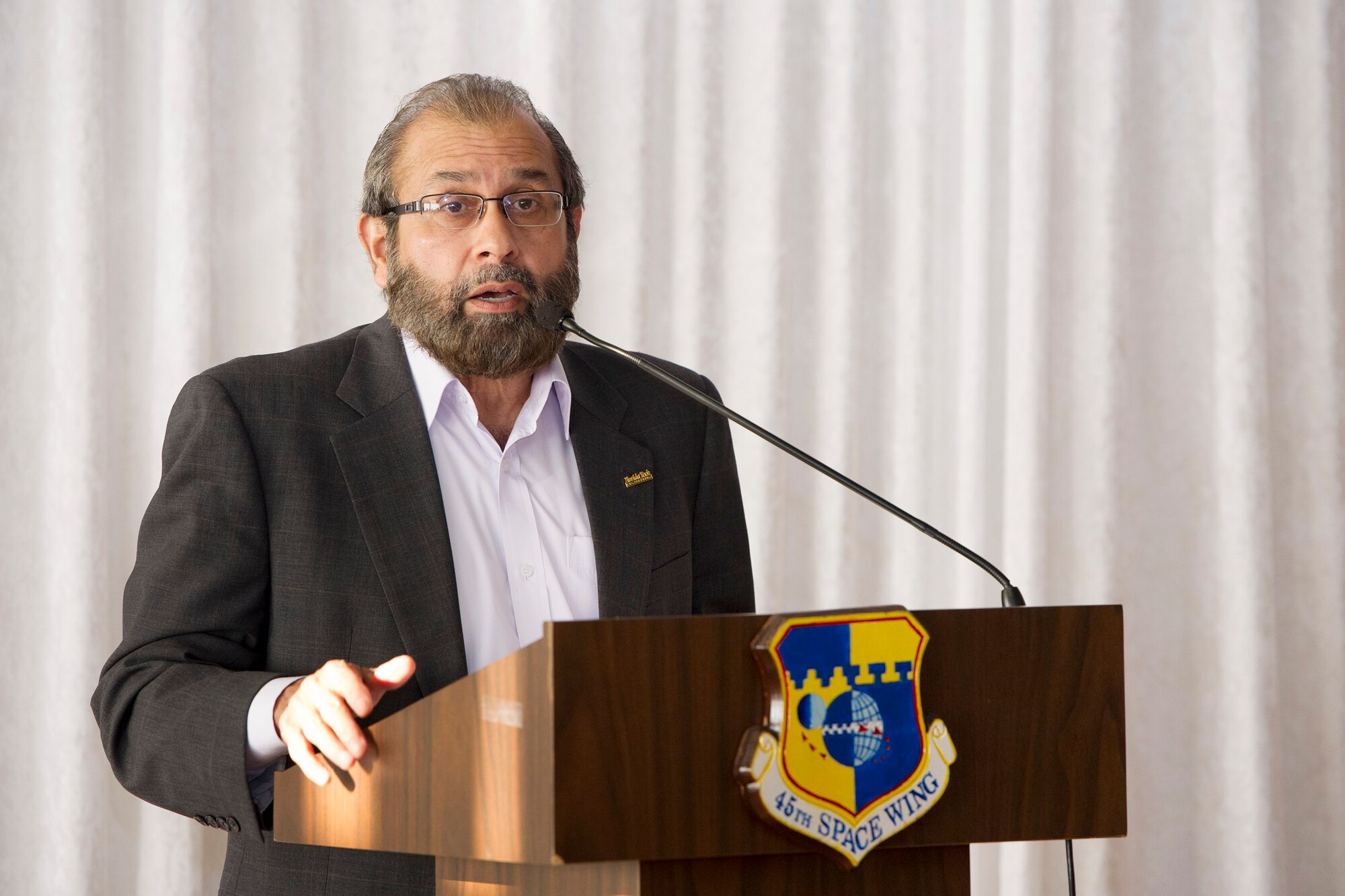 Dr. Muzaffar Shaikh, of Florida Institute of Technology, reads an Islamic scripture from the Hadith Qudsi during the National Prayer Breakfast, May 1, at the Tides Club at Patrick Air Force Base, Fla. Each representative shared their religious reading with Team Patrick-Cape on the topic related to the difference between hearing and listening. (U.S. Air Force photo/Matthew Jurgens) 