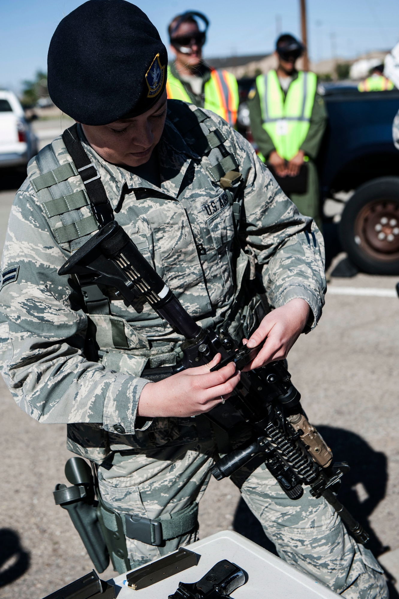 A member from the 49th Security Forces Squadron loads her weapon with rubber bullets before an active shooter exercise April 30, 2015 at Holloman Air Force Base, N.M. SFS members responded to, and neutralized the simulated threat. The 49th Civil Engineer Squadron and the 49th Medical Group provided medical support to the “victims.” (U.S. Air Force Photo by Airman 1st Class Emily A. Kenney/Released) 