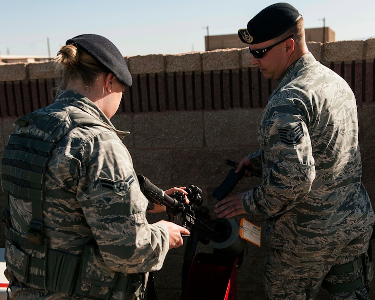 A member from the 49th Security Forces Squadron clears her weapon of live ammunition before participating in an active shooter exercise April 30, 2015 at Holloman Air Force Base, N.M. Multiple times per year, Holloman hosts active shooter exercises to test and maintain readiness in case of a real-world emergency. (U.S. Air Force photo by Airman 1st Class Emily A. Kenney/Released) 