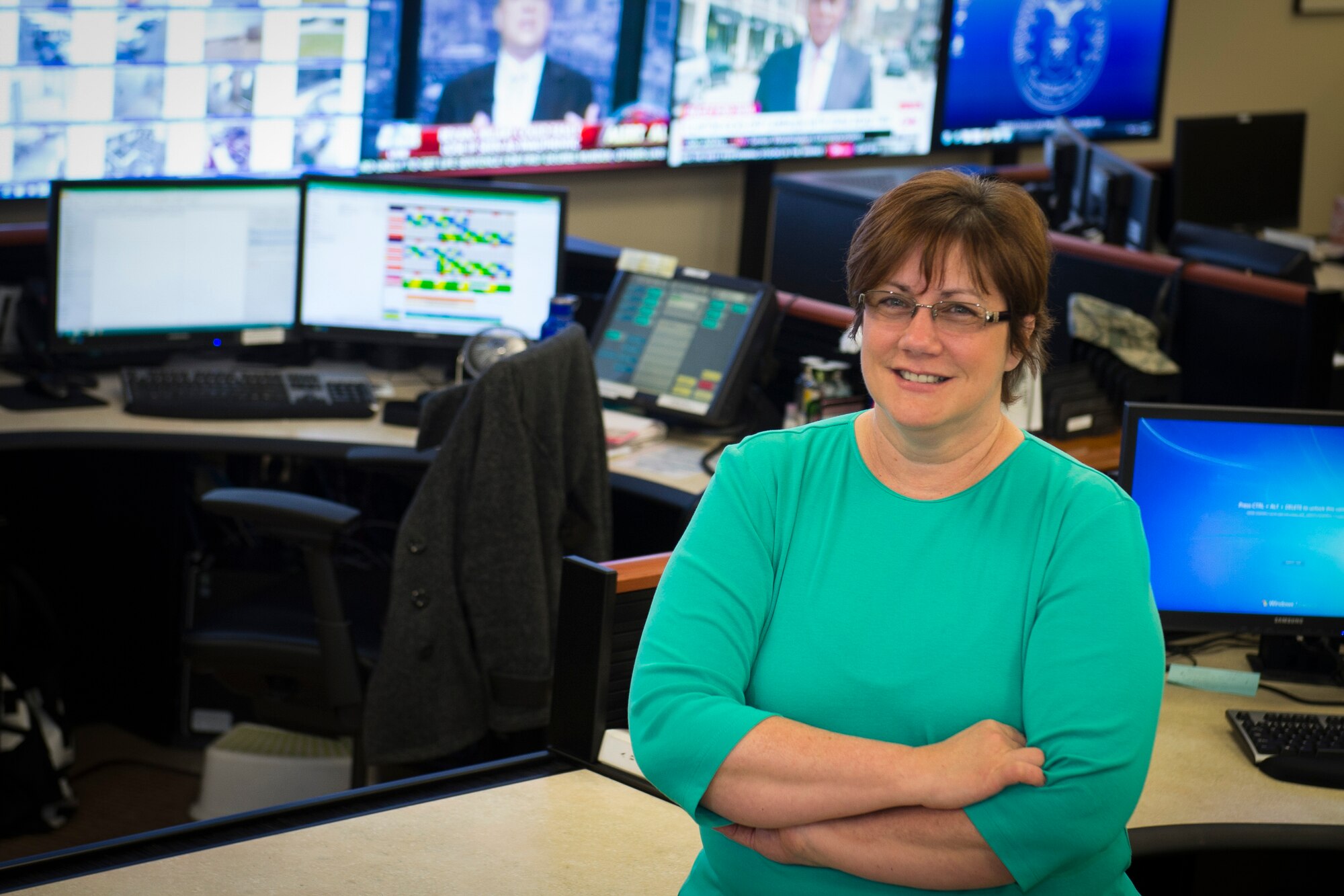 Robin Vitale, Air Force Mortuary Affairs Operations Command, Control and Communication manager, poses in the operations center April 12, 2015. Vitale was named the 2014 A1 Manager of the Year.  (U.S. Air Force photo by Senior Airman Stacy Buckley/Released)