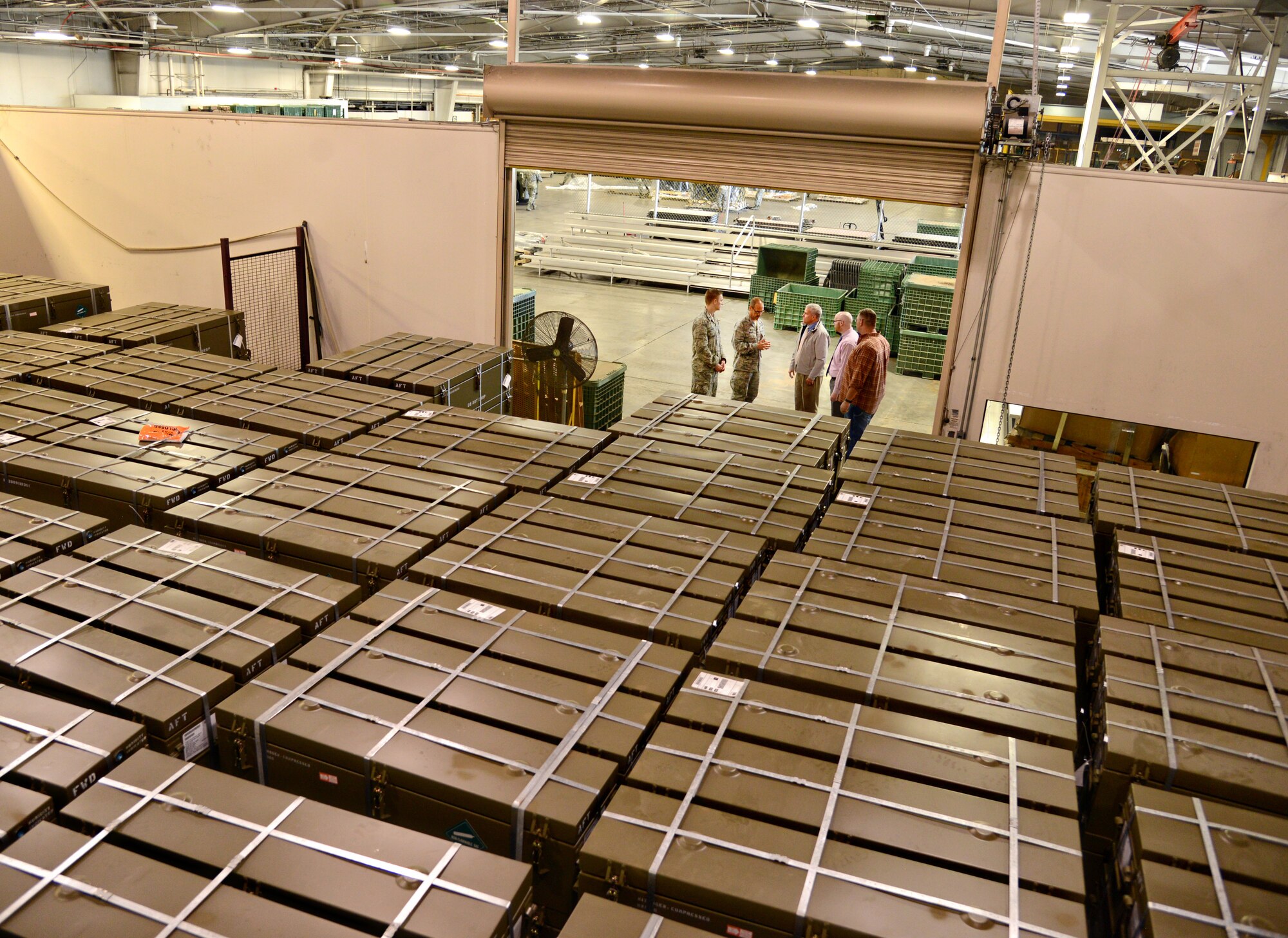 Discussing a movement of a foreign military sales shipment are, from left, 1st Lt. Travis Hough, 72nd Mission Support Group executive officer; Col. Todd Vician, 72nd MSG commander; Stephen Walker, 72nd Logistics Readiness Squadron director; Brent Burgess, 72nd LRS Operations manager; and Steve Max, 72nd LRS Air Terminal Operations and Passenger Travel chief. The shipment includes approximately $13 million worth of equipment. Members of the 72nd LRS built approximately 70 pallets containing the 297,000 pounds of equipment, which will be shipped out soon. (Air Force photo by Kelly White/Released)