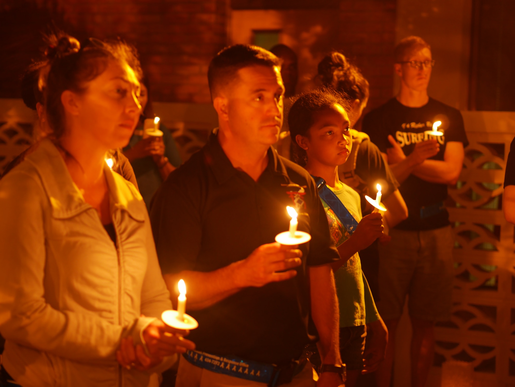 Participants of Take Back the Night march illuminate the night together in the Chapel 2 courtyard on Kadena Air Base, Japan, May 1, 2015. Together they banished the darkness in the courtyard symbolizing unity and togetherness. (U.S. Air Force photo/Senior Airman Omari Bernard)