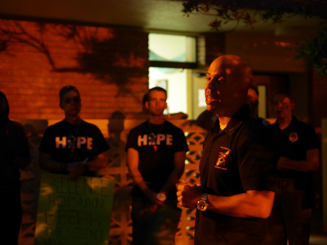 Master Sgt. Joseph Mageau, 18 Civil Engineer Group first sergeant, tells participants of Take Back the Night about his experience with sexual assault in the Chapel 2 courtyard on Kadena Air Base, Japan, May 1, 2015. During the event mandatory reporters explained the importance of leadership reporting sexual assault and their experiences of reporting. (U.S. Air Force photo/Senior Airman Omari Bernard)
