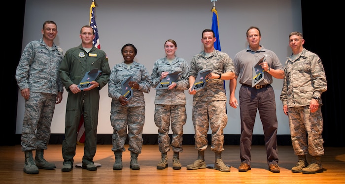 Col. John Lamontagne, 437th Airlift Wing commander, and CMSgt Shawn Hughes, 437th AW command chief, congratulate the award winners of the 437th AW 1st Quarterly Awards April 30, 2015, at the base theater on Joint Base Charleston, S.C. The Quarterly Awards are held to recognize outstanding Airmen, non-commissioned officers, senior non-commissioned officers, company grade officers and civilians for their hard work and dedication. (U.S. Air Force photo/ Airman 1st Class Clayton Cupit)