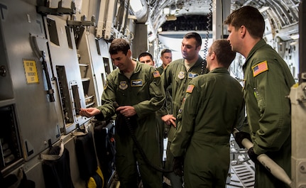 Loadmasters from the 14th Airlift Squadron practice proper use of equipment April 29, 2015, for a C-17 Globemaster III on Joint Base Charleston, S.C. The 14th AS, 437th Logistics Readiness Squadron, 437th Maintenance Group, Mt. Pleasant Special Weapons And Tactics, Dorchester County Sheriff’s Office and 437th Ariel Port Squadron conducted a static loading exercise with simulated Mine-Resistant Ambush Protected vehicles. The exercise included loading, winching and aircraft refueling training for newly deploying loadmasters. (U.S. Air Force photo/Airman 1st Class Clayton Cupit)