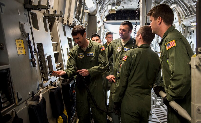 Loadmasters from the 14th Airlift Squadron practice proper use of equipment April 29, 2015, for a C-17 Globemaster III on Joint Base Charleston, S.C. The 14th AS, 437th Logistics Readiness Squadron, 437th Maintenance Group, Mt. Pleasant Special Weapons And Tactics, Dorchester County Sheriff’s Office and 437th Ariel Port Squadron conducted a static loading exercise with simulated Mine-Resistant Ambush Protected vehicles. The exercise included loading, winching and aircraft refueling training for newly deploying loadmasters. (U.S. Air Force photo/Airman 1st Class Clayton Cupit)