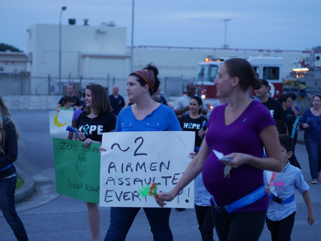 Members of Team Kadena march and chant to raise awareness of sexual assault prevention during the Take Back the Night event on Kadena Air Base, Japan, May 1, 2015. Take Back the Night is a rally, a march and a time to reflect for the survivors of sexual assault. (U.S. Air Force photo/Senior Airman Omari Bernard)