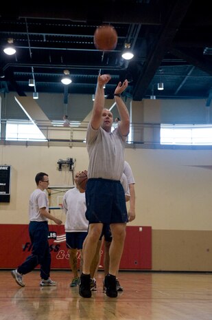 Maj. Brad Prisbe, 328th Weapons Squadron space weapons instructor, shoots a free-throw during a unit physical training basketball game at the Warrior Fitness Center on Nellis Air Force Base, Nev., April 15, 2015. Basketball is a popular and casual way to exercise, and is an aerobic sport that can help burn calories, build endurance and muscle, and improve balance and coordination. (U.S. Air Force photo by Airman 1st Class Rachel Loftis) 