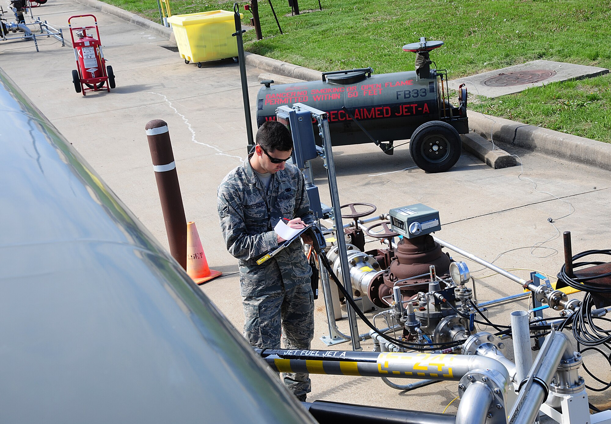 Airman 1st Class Jake McSheffrey, 509th Logistics Readiness Squadron fuels distribution technician, completes paperwork during a filling operation at Whiteman Air Force Base, Mo., April 23, 2015. Completing paperwork is paramount for maintaining accountability of fuel distribution. (U.S. Air Force photo by Senior Airman Keenan Berry/Released) 