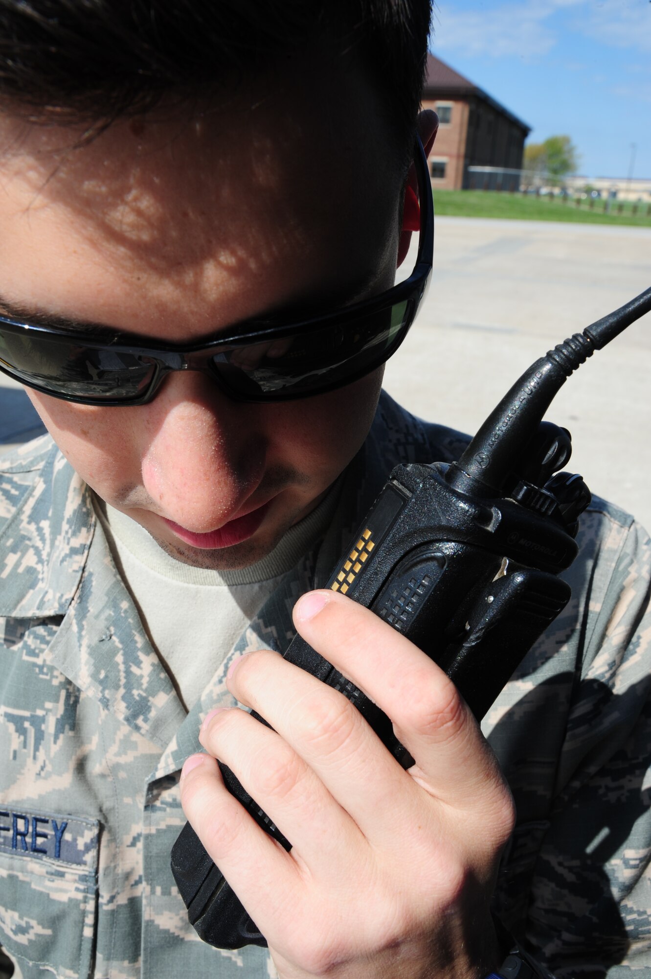 Airman 1st Class Jake McSheffrey, 509th Logistics Readiness Squadron fuels distribution technician, relays a message on his radio at Whiteman Air Force Base, Mo., April 23, 2015. Constant communication between operators and the control center ensures tasks are completed efficiently. (U.S. Air Force photo by Senior Airman Keenan Berry/Released) 