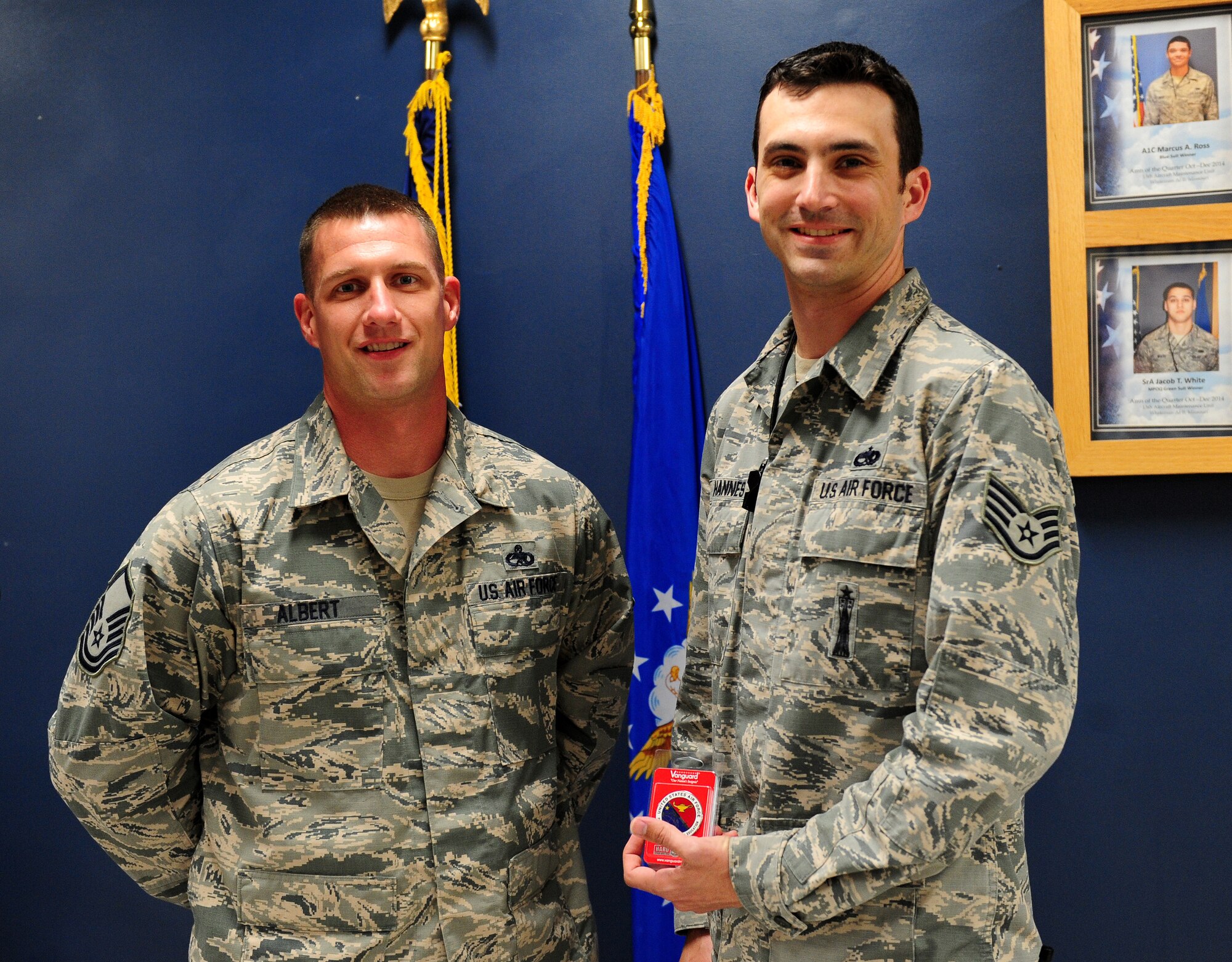 U.S. Air Force Staff Sgt. Erik Johannes, 509th Aircraft Maintenance Squadron weapons load crew member, poses with Master Sgt. Josef Albert, Airman Leadership School commandant, after being notified of his selection for a developmental special duty at Whiteman Air Force Base, Mo., April 24, 2015.  Johannes is slated to become the newest instructor as part of the Whiteman ALS team. (U.S. Air Force photo by Airman 1st Class Joel Pfiester/Released)