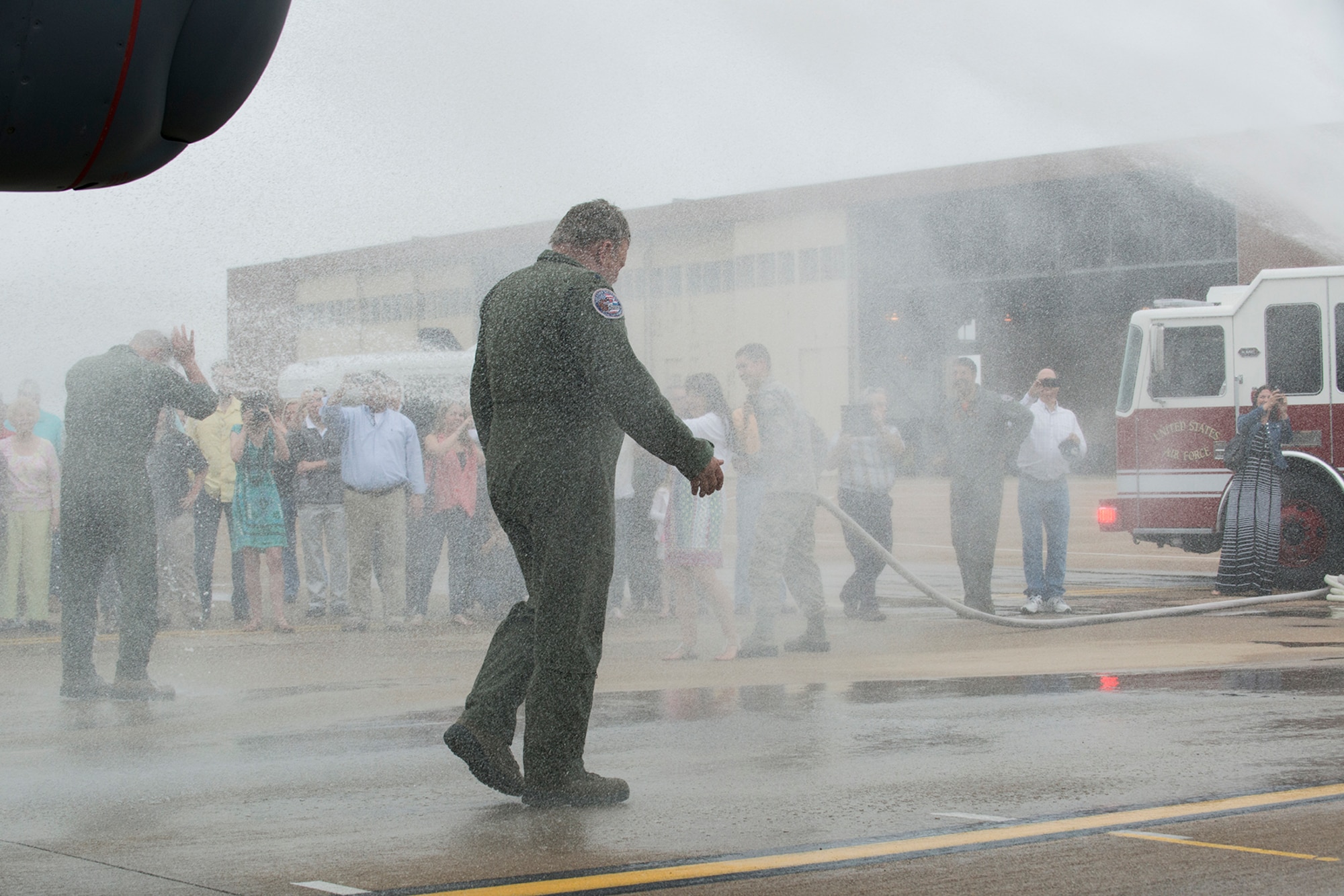 U.S. Air Force Lt. Cols. David Knesek and Jeffrey Stogsdill get hose down after returning from their last mission on April 24, 2015, Barksdale Air Force Base, La. Knesek and Stogsdill are both B-52H Stratofortress pilots and are retiring from the Air Force Reserve. (U.S. Air Force photo by Master Sgt. Greg Steele/Released)