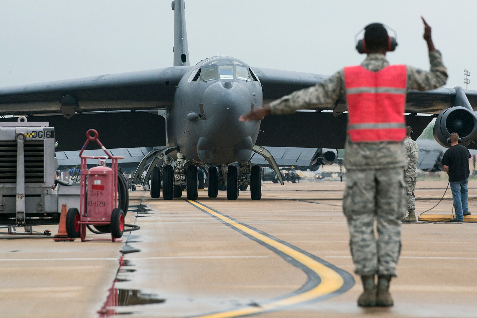 U.S. Air Force Senior Airman Kashawn Gresham marshals a 307th Bomb Wing B-52H Stratofortress after its return from a mission on April 24, 2015, Barksdale Air Force Base La. Piloting the aircraft for the last time aret are Lt. Cols. Jeffrey Stogsdill and David Knesek who are both retiring from the Air Force Reserve. (U.S. Air Force photo by Master Sgt. Greg Steele/Released)