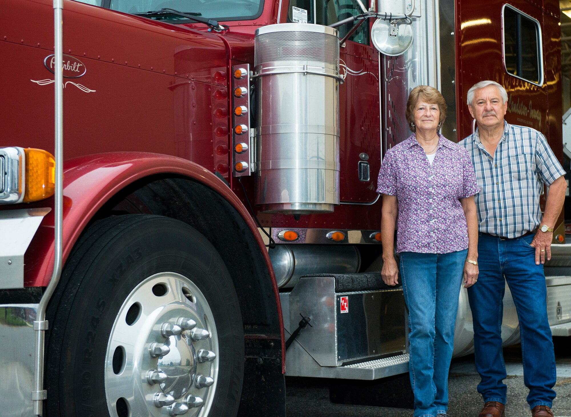 Joyce and Henry, U.S. Air Force contractors, pose for a photo April 16, 2015, at Moody Air Force Base, Ga. The truck driving team hauls aircraft parts and repairable assets to assist the 23d Maintenance Group in ensuring mission readiness and have driven over one million miles together. (U.S. Air Force photo by Airman 1st Class Ceaira Tinsley/Released)
