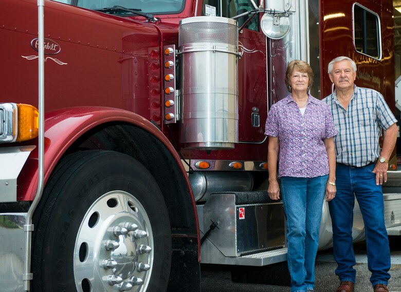 Joyce and Henry, U.S. Air Force contractors, pose for a photo April 16, 2015, at Moody Air Force Base, Ga. The truck driving team hauls aircraft parts and repairable assets to assist the 23d Maintenance Group in ensuring mission readiness and have driven over one million miles together. (U.S. Air Force photo by Airman 1st Class Ceaira Tinsley/Released)