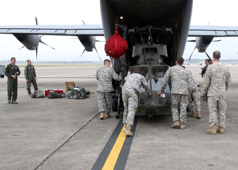 Troopers from Alpha Troop, 1st Squadron, 17th Cavalry Regiment, 82nd Combat Aviation Brigade, move an OH-58 Kiowa Warrior to a C-130 Hercules in preparation for an upcoming mission, Pope Airfield, April 14. The Kiowa will be used to provide aerial reconnaissance in support of the Combined Joint Operational Access Exercise 15-01 at Fort Bragg, N.C. (U.S. Army photo by Staff Sgt. Christopher Freeman/82nd Combat Aviation Brigade Public Affairs)
