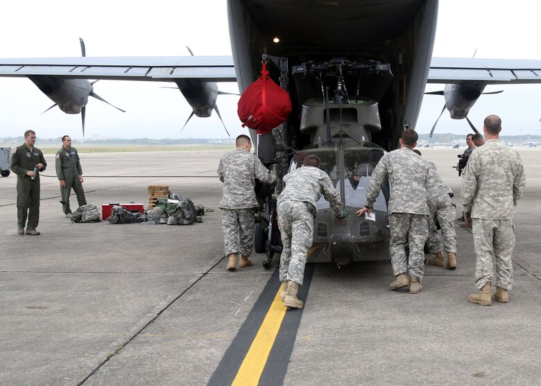 Troopers from Alpha Troop, 1st Squadron, 17th Cavalry Regiment, 82nd Combat Aviation Brigade, move an OH-58 Kiowa Warrior to a C-130 Hercules in preparation for an upcoming mission, Pope Airfield, April 14. The Kiowa will be used to provide aerial reconnaissance in support of the Combined Joint Operational Access Exercise 15-01 at Fort Bragg, N.C. (U.S. Army photo by Staff Sgt. Christopher Freeman/82nd Combat Aviation Brigade Public Affairs)
