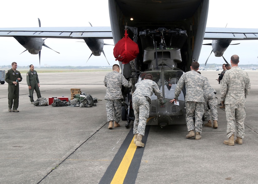 Troopers from Alpha Troop, 1st Squadron, 17th Cavalry Regiment, 82nd Combat Aviation Brigade, move an OH-58 Kiowa Warrior to a C-130 Hercules in preparation for an upcoming mission, Pope Airfield, April 14. The Kiowa will be used to provide aerial reconnaissance in support of the Combined Joint Operational Access Exercise 15-01 at Fort Bragg, N.C. (U.S. Army photo by Staff Sgt. Christopher Freeman/82nd Combat Aviation Brigade Public Affairs)
