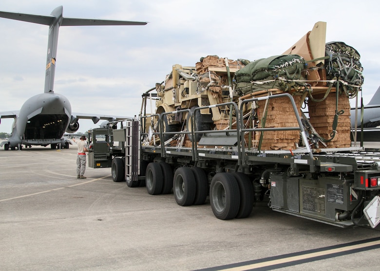 Vehicles and equipment are loaded onto a U.S. Air Force C-17 Globemaster III on Pope Army Airfield, N.C., April 13, 2015. The equipment was parachute-dropped as part of a mass tactical airborne operation, which kicked off Combined Joint Operational Access Exercise 15-01, led by the 2nd Brigade Combat Team, 82nd Airborne Division and is the largest bilateral exercise held on Fort Bragg in almost 20 years. (Photo by Staff Sgt. Jason Hull, 82nd Airborne Division)
