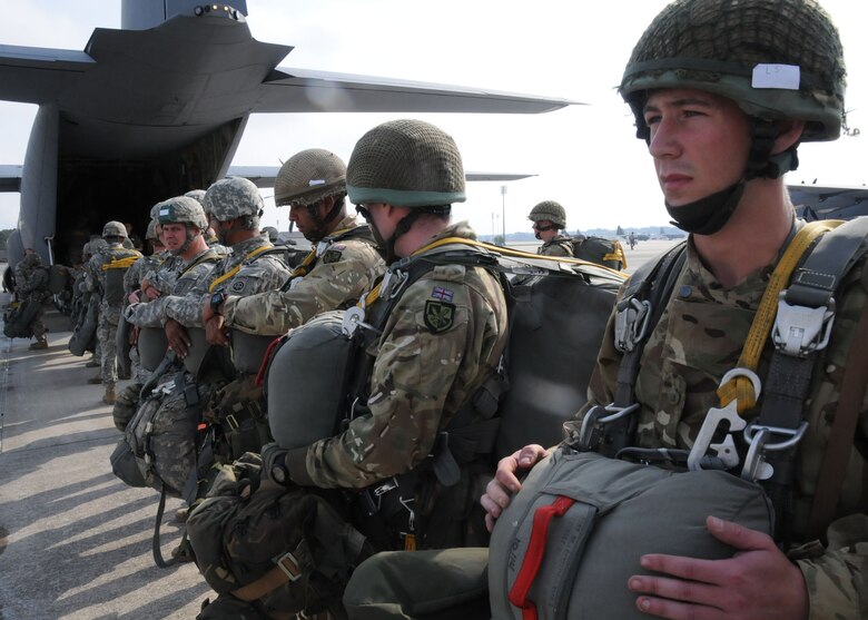 British Cannoneers from the 7th Royal Horse Artillery, 3rd Parachute Regiment prepare to jump alongside their American counterparts with 2nd Battalion, 319th Airborne Field Artillery Regiment, 82nd Airborne Division Artillery in preparation for an artillery live fire mission from the drop zone. (Capt. Joe Bush, 82nd Airborne DIVARTY/Released)
